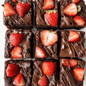 These Chocolate Covered Strawberry Brownies are the ultimate dessert that combines rich chocolate brownie goodness with fresh, juicy strawberries. Topped with a luscious layer of chocolate and adorned with delightful strawberry halves, they're perfect for impressing guests at parties or enjoying a sweet treat at home. Save this recipe for your next gathering or indulgent date night!