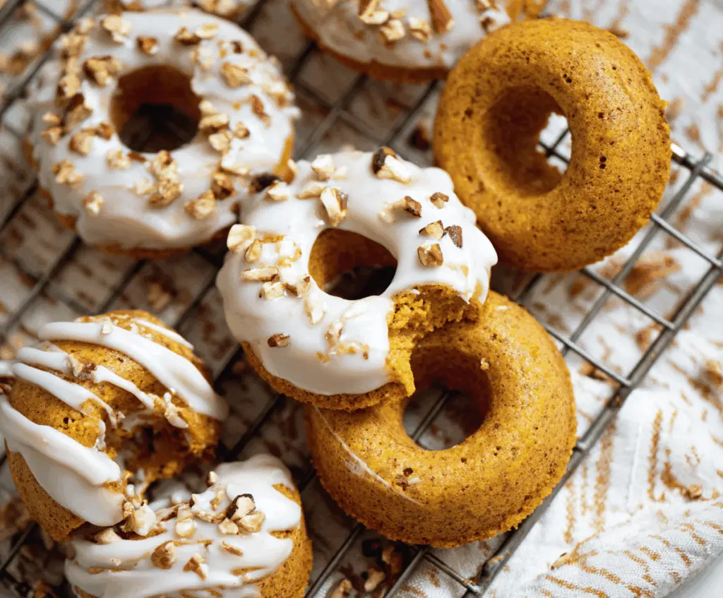 Delicious baked pumpkin donut treats topped with cinnamon and powdered sugar on a festive plate
