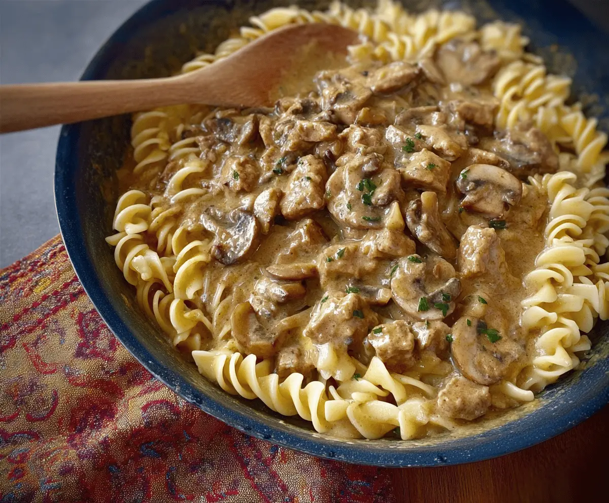 Creamy mushroom and seitan stroganoff served over noodles, featuring hearty seitan, sautéed mushrooms, and rich sauce in a delicious vegan recipe