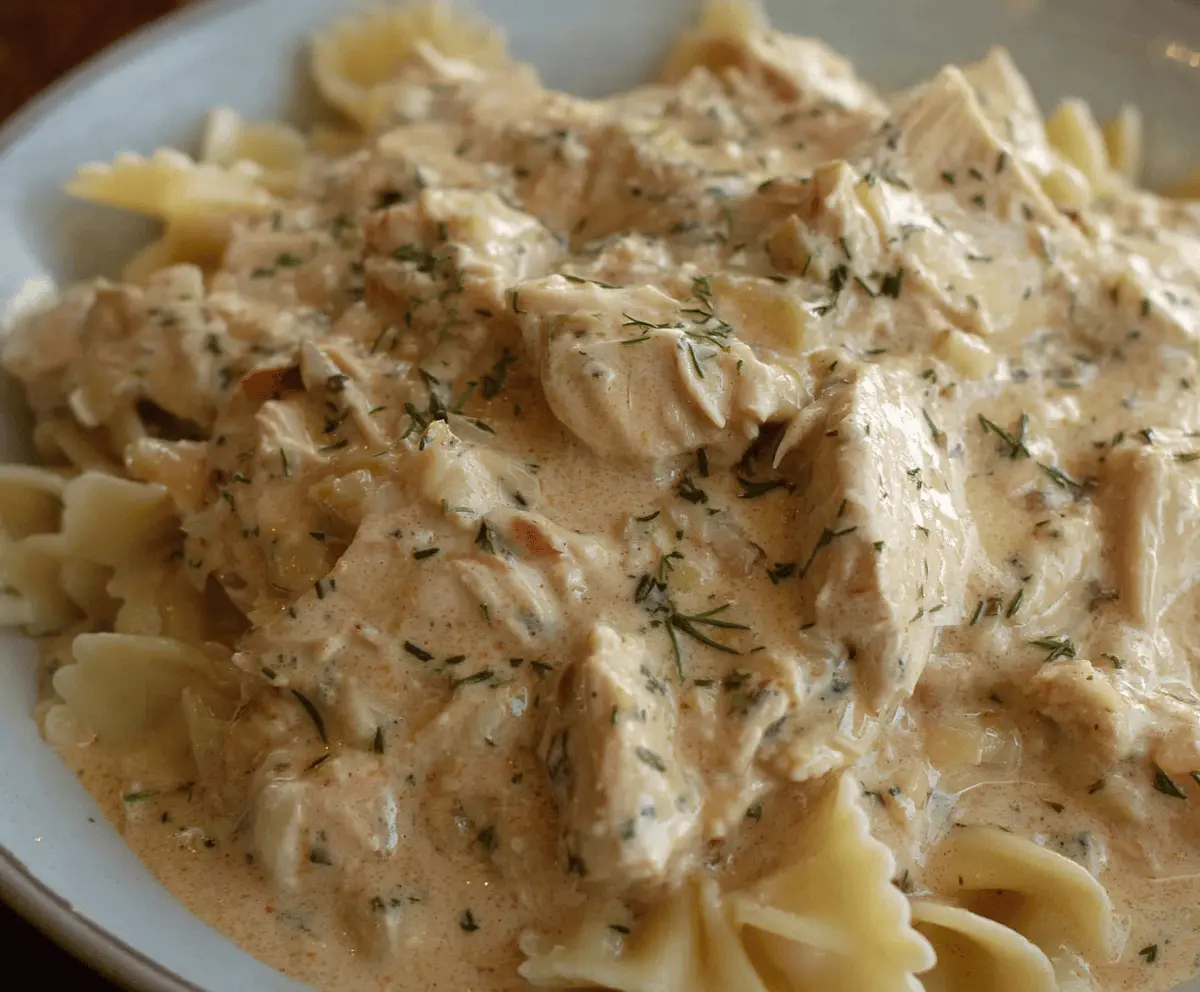 Creamy Ranch Chicken cooked in a crockpot, served with fresh herbs and vegetables for a delicious and easy dinner