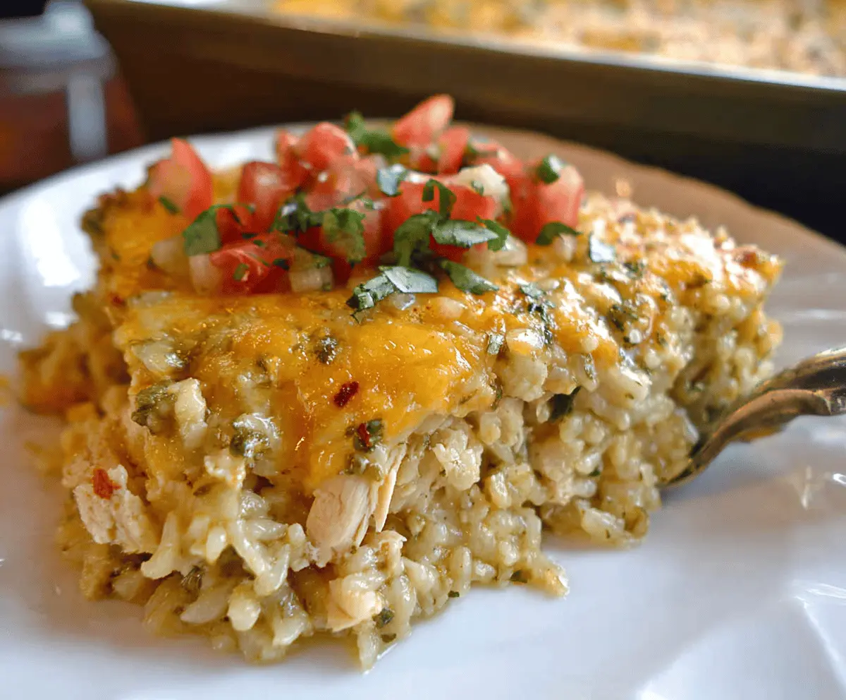Delicious Salsa Verde Chicken and Rice Casserole with melted cheese and fresh herbs, served in a baking dish