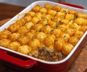 Delicious Tater Tot Casserole with golden crispy Tater Tots, savory beef, melted cheese, and creamy topping served in a baking dish