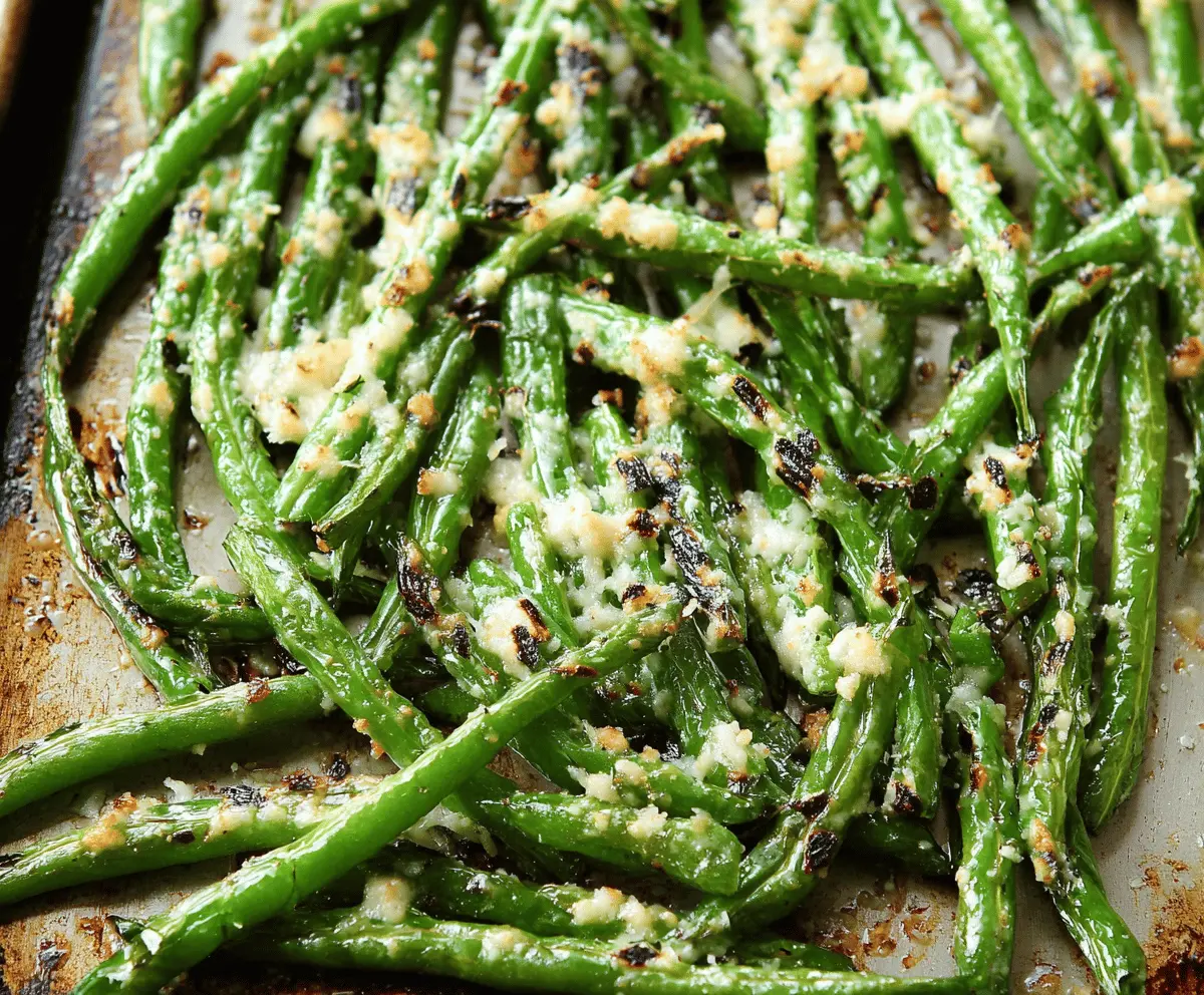 Delicious roasted green beans topped with grated Parmesan cheese, served as a flavorful side dish